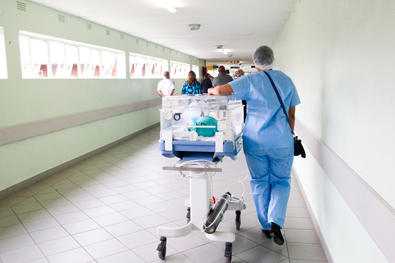 Medical professional with equipment in hallway