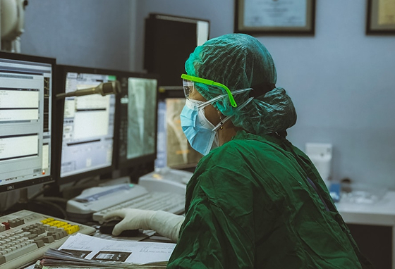Medical professional in green scrubs working